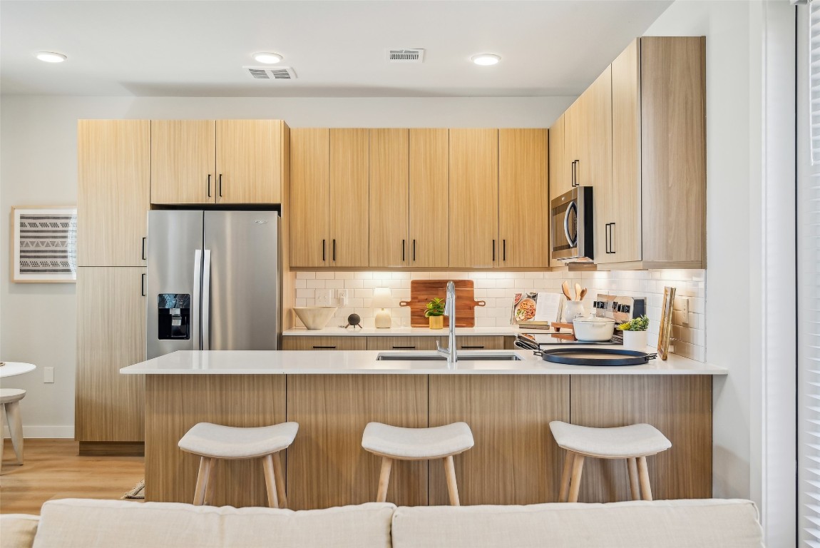 3651-210 South Custer Road McKinney, TX 75070 - Photo 16 of 28 a kitchen with stainless steel appliances granite countertop a sink and a white cabinets