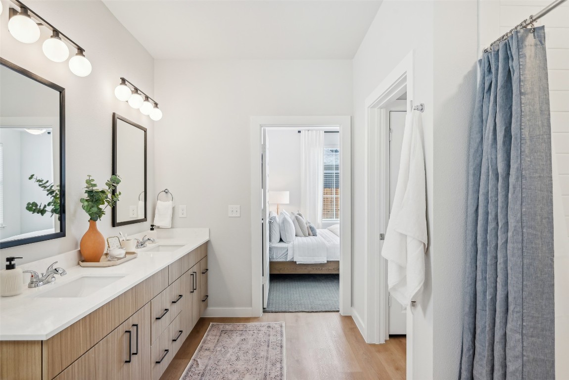 3651-210 South Custer Road McKinney, TX 75070 - Photo 24 of 28 a en suite bathroom with a double vanity sink a mirror and shower