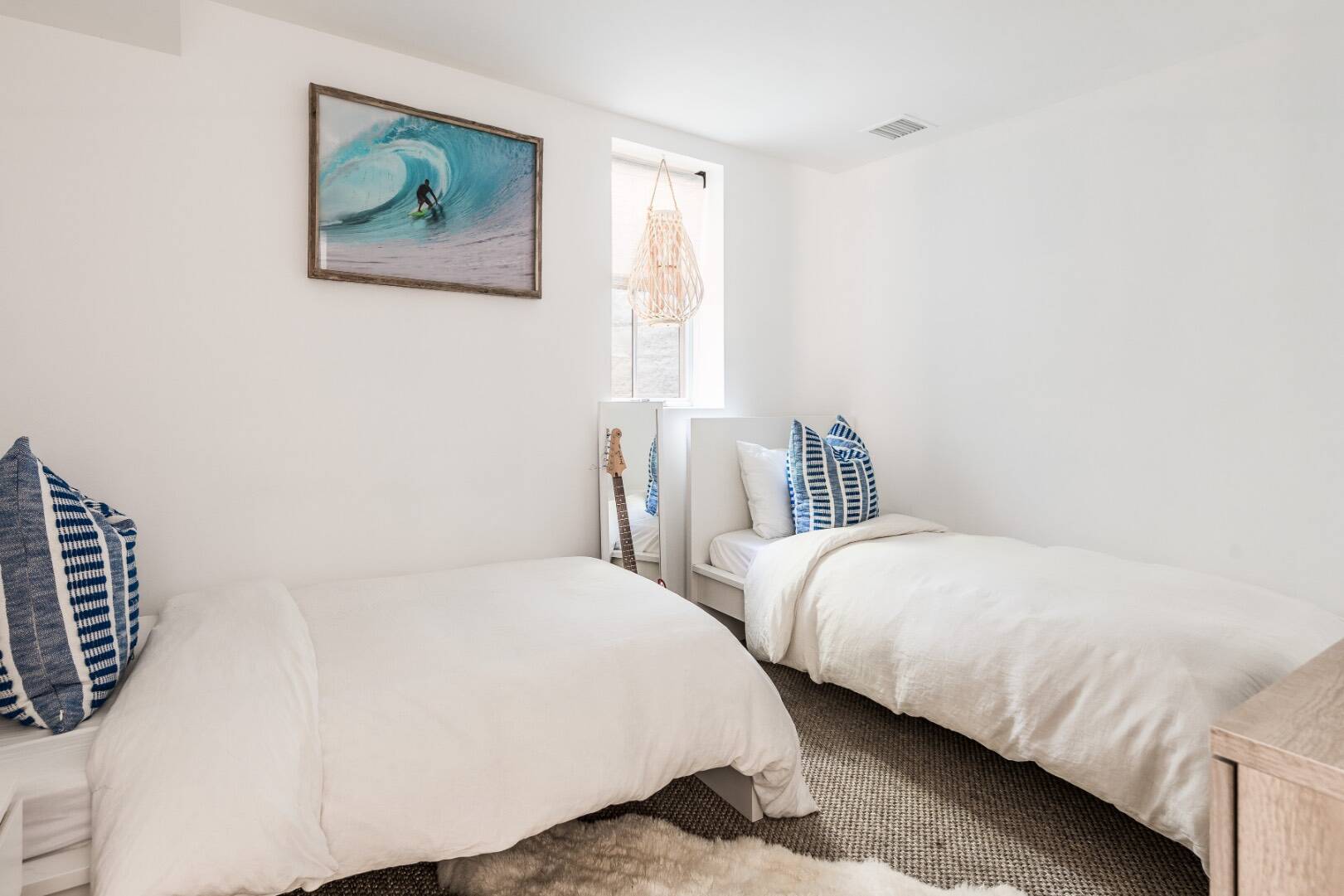 5 Fort Hill Road Montauk, NY 11954 - Photo 11 of 11 a bedroom with two beds and a painting on the wall