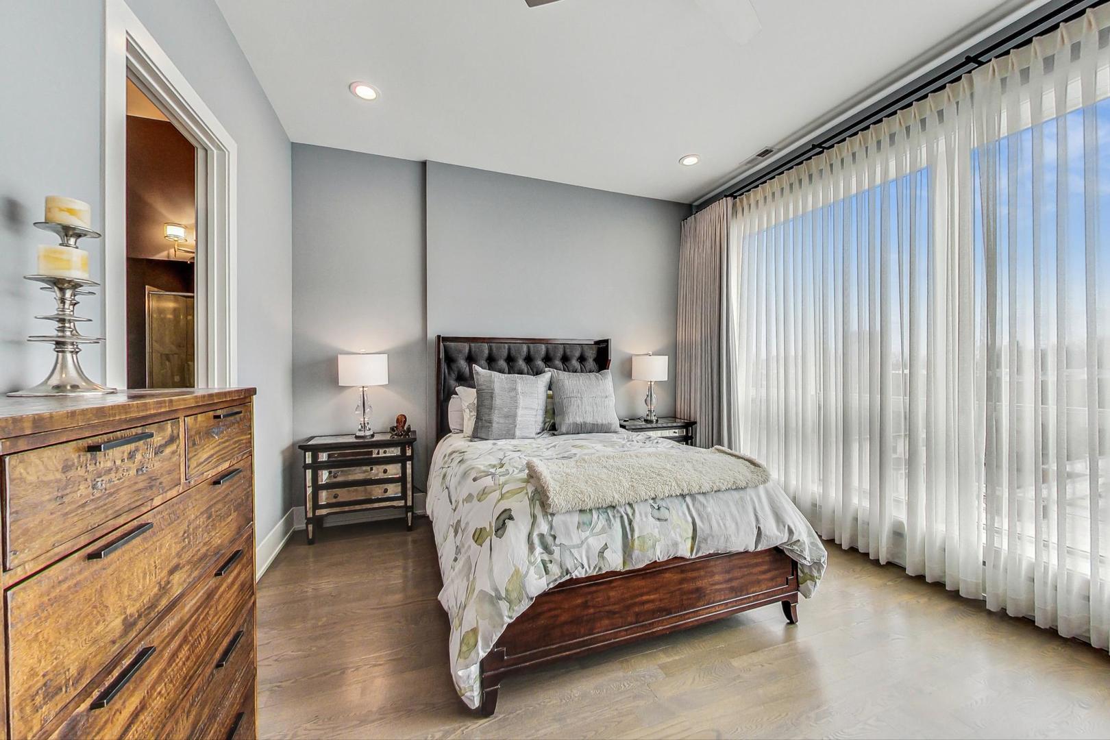 4042 North Pulaski Road, Unit 4E Chicago, IL 60641 - Photo 11 of 32 a bedroom with a bed and large windows