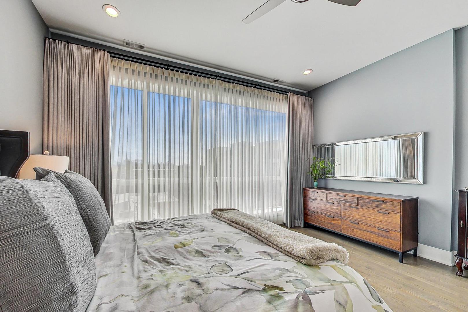 4042 North Pulaski Road, Unit 4E Chicago, IL 60641 - Photo 12 of 32 a bedroom with a bed and a window