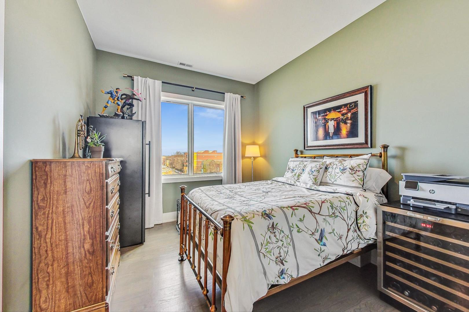 4042 North Pulaski Road, Unit 4E Chicago, IL 60641 - Photo 16 of 32 a bedroom with a bed and a table in it