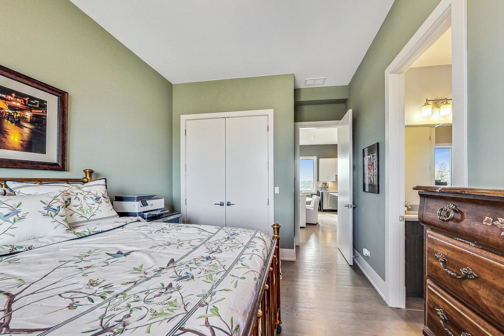 4042 North Pulaski Road, Unit 4E Chicago, IL 60641 - Photo 18 of 32 a bedroom with a bed and a tv on a dresser