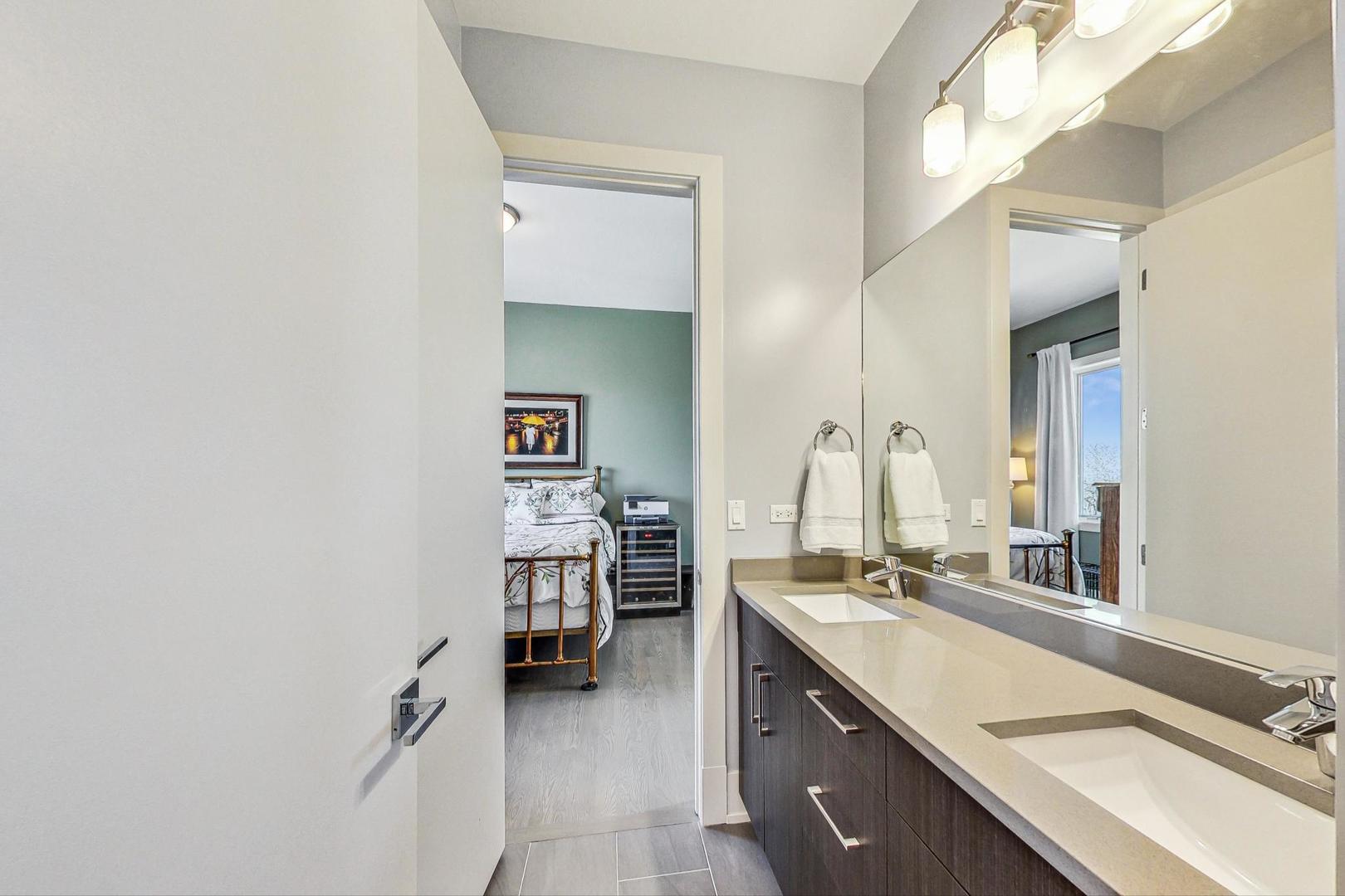 4042 North Pulaski Road, Unit 4E Chicago, IL 60641 - Photo 20 of 32 a spacious bathroom with a double vanity sink a mirror and a