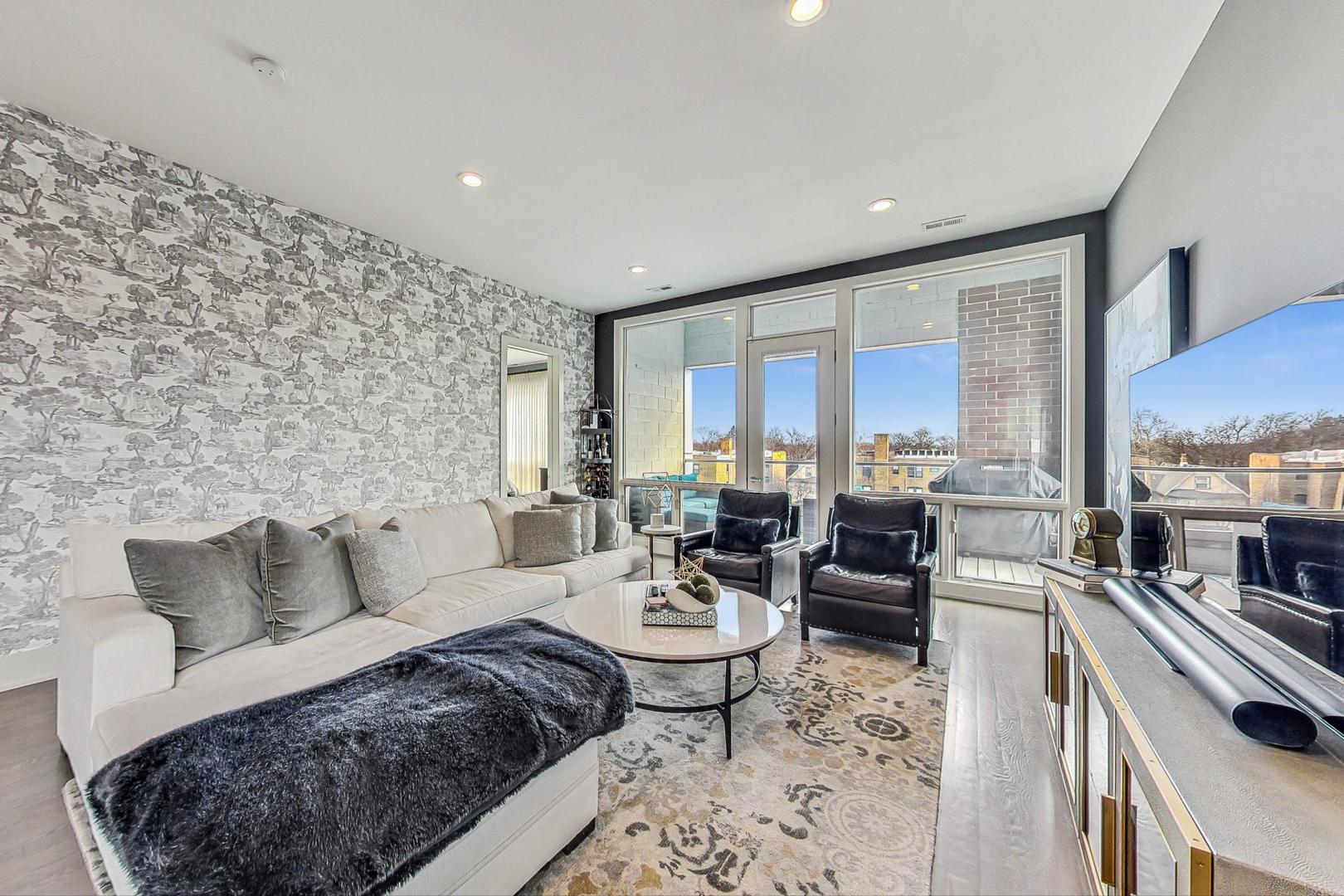4042 North Pulaski Road, Unit 4E Chicago, IL 60641 - Photo 2 of 32 a living room with furniture wooden floor and a view of kitchen