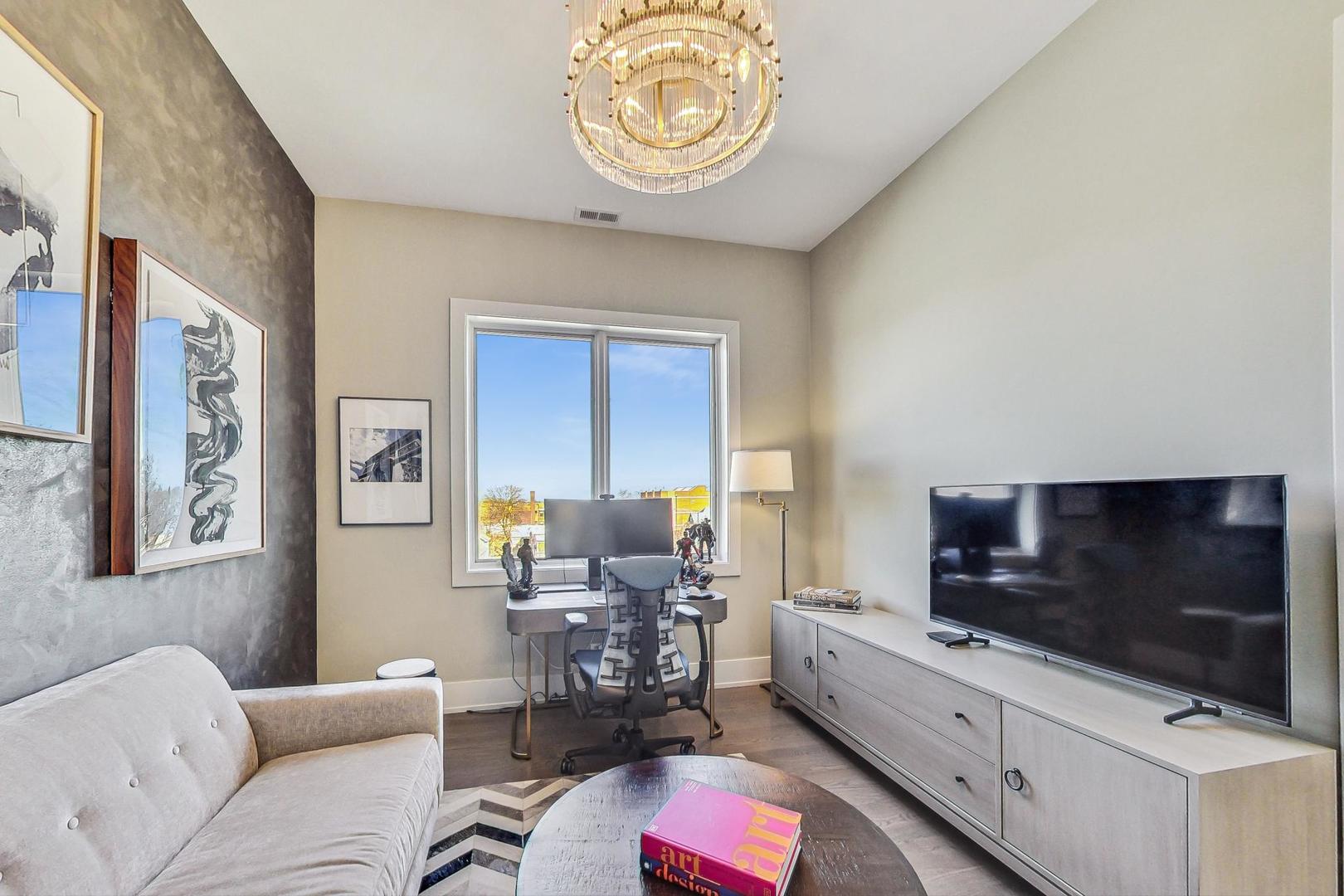 4042 North Pulaski Road, Unit 4E Chicago, IL 60641 - Photo 22 of 32 a living room with furniture and a flat screen tv