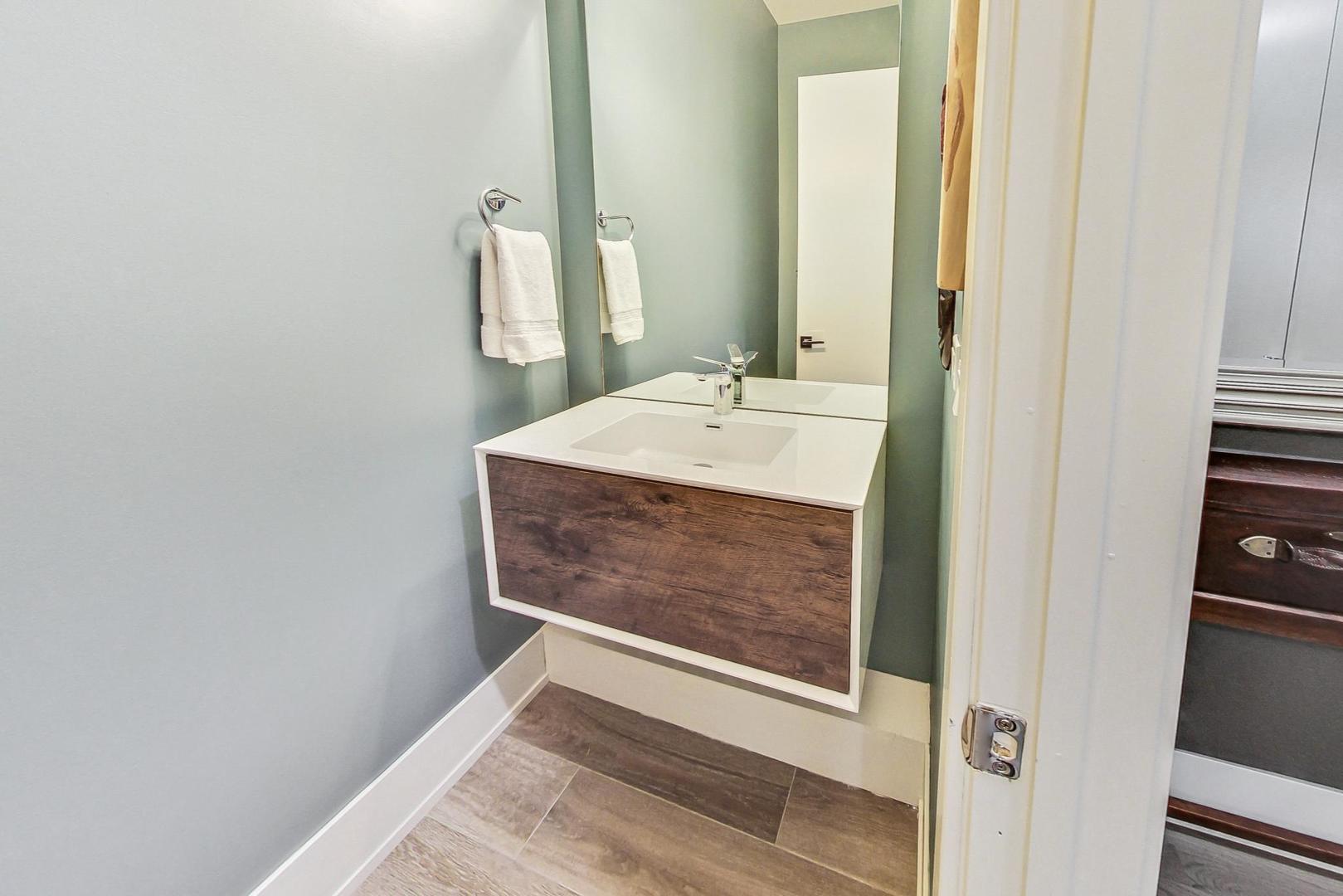 4042 North Pulaski Road, Unit 4E Chicago, IL 60641 - Photo 25 of 32 a bathroom with a sink and a mirror