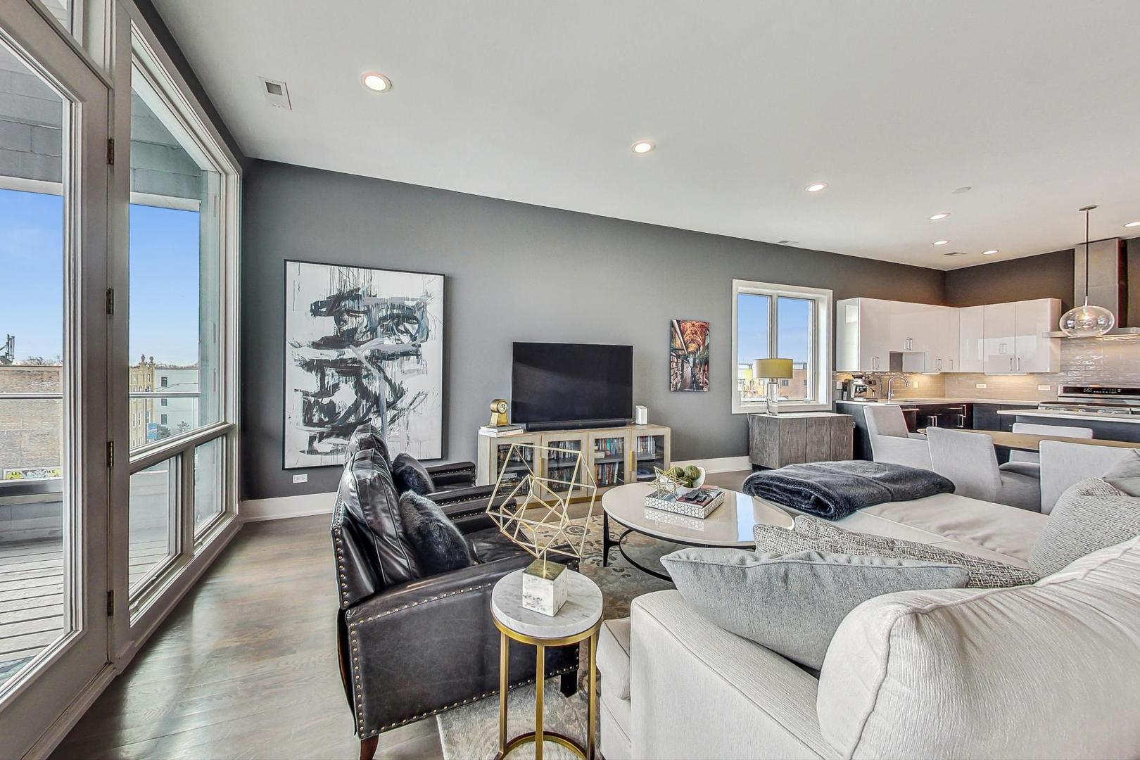 4042 North Pulaski Road, Unit 4E Chicago, IL 60641 - Photo 4 of 32 a living room with furniture or flat screen tv and a large window