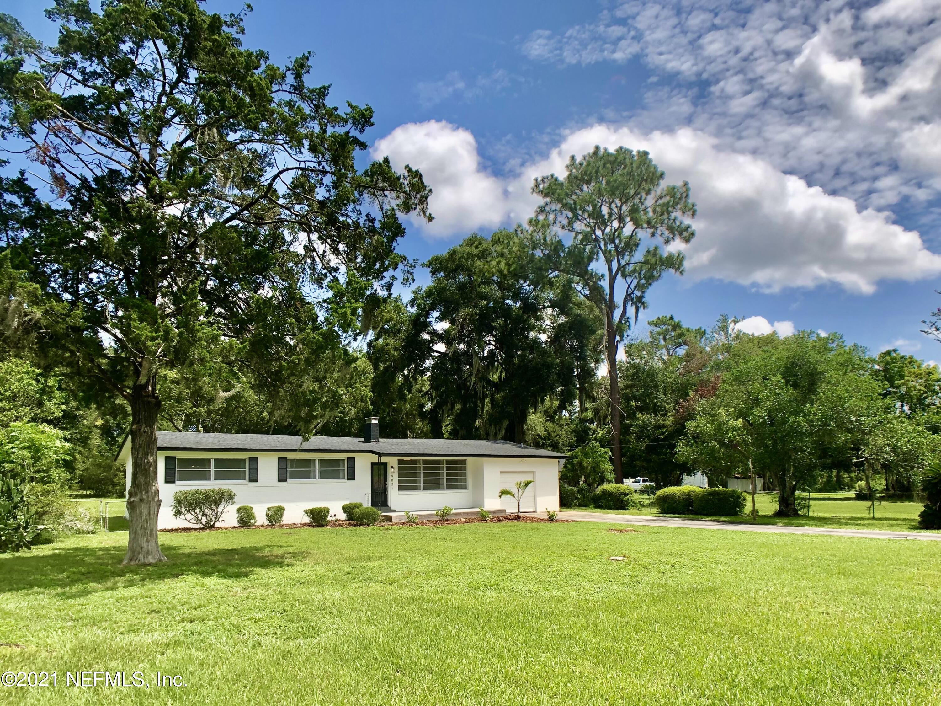 9831 Cunningham Road Jacksonville, FL 32246 - Photo 1 of 25 a front view of a house with a garden
