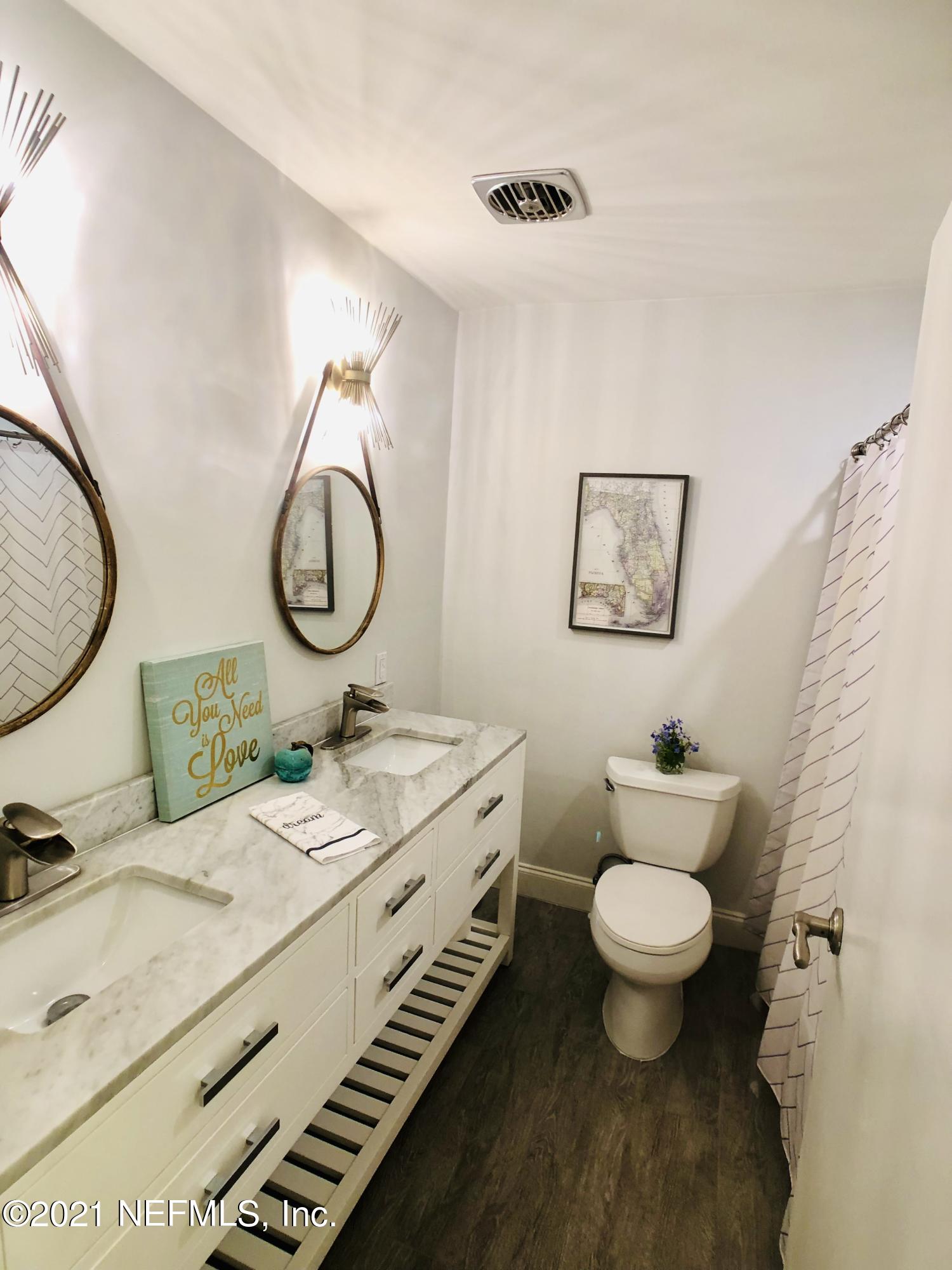 9831 Cunningham Road Jacksonville, FL 32246 - Photo 13 of 25 a bathroom with a granite countertop toilet sink and mirror