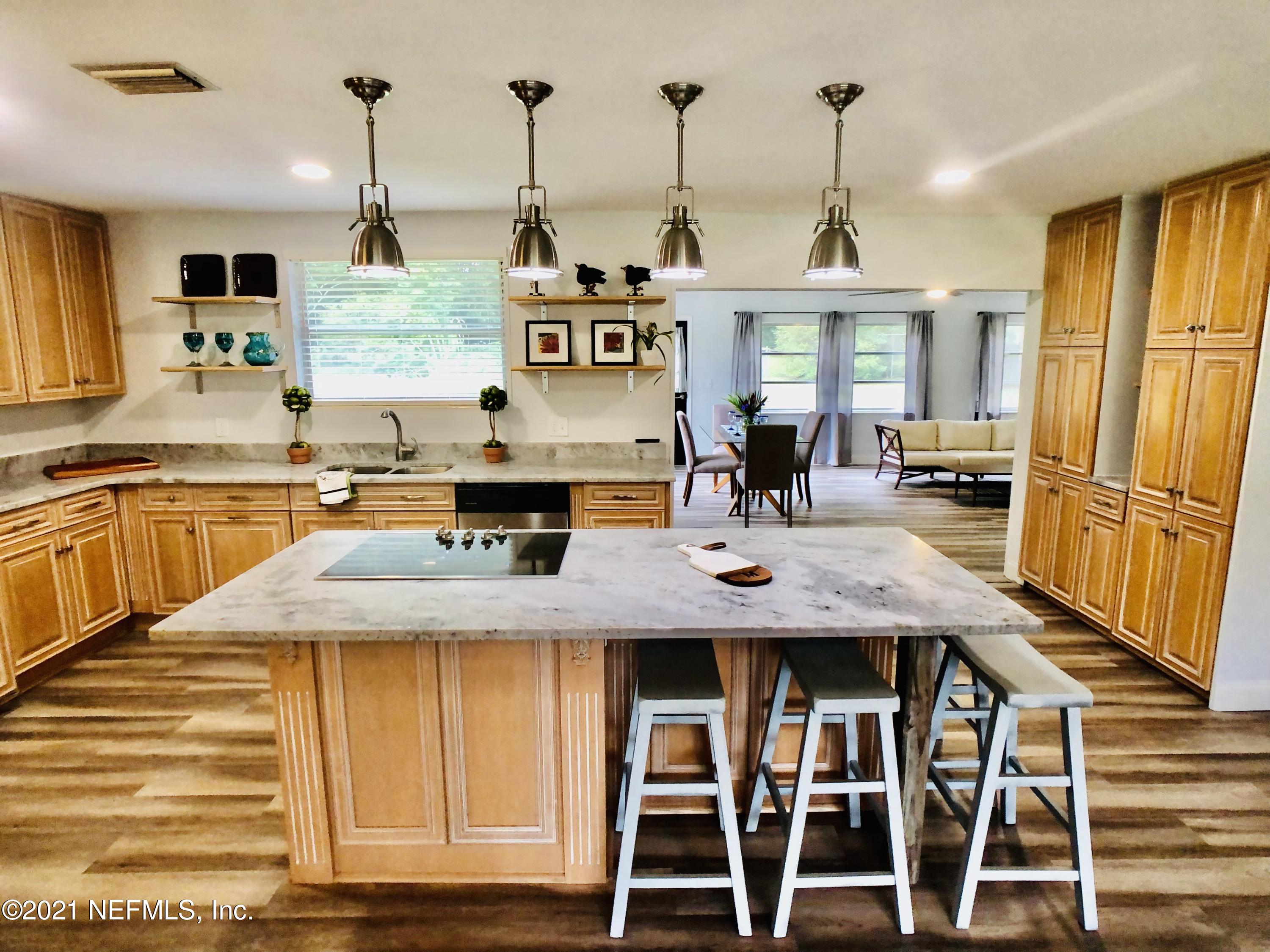 9831 Cunningham Road Jacksonville, FL 32246 - Photo 7 of 25 a view of a kitchen counter space and wooden floor