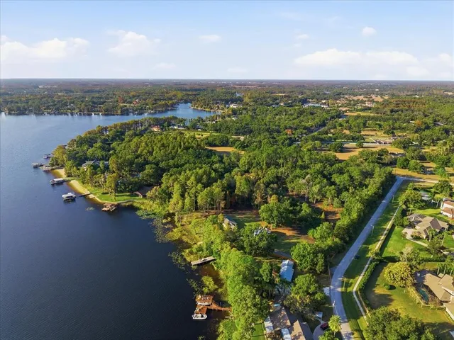 an aerial view of a house with a lake view