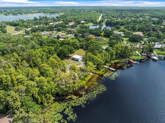 an aerial view of a houses with a yard