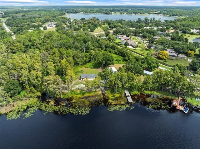 an aerial view of a houses with a yard