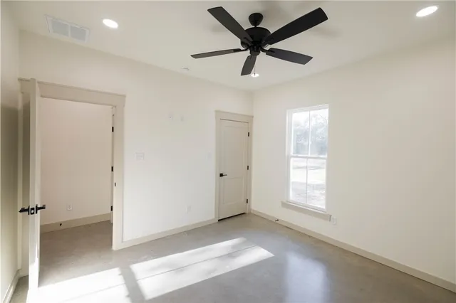 a view of a livingroom with a ceiling fan and window