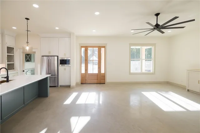 a view of a kitchen with a sink stainless steel appliances and cabinets