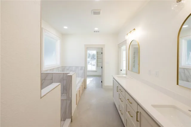 a bathroom with a double vanity sink and a mirror