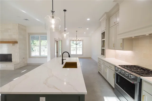 a kitchen with a stove a sink and a refrigerator