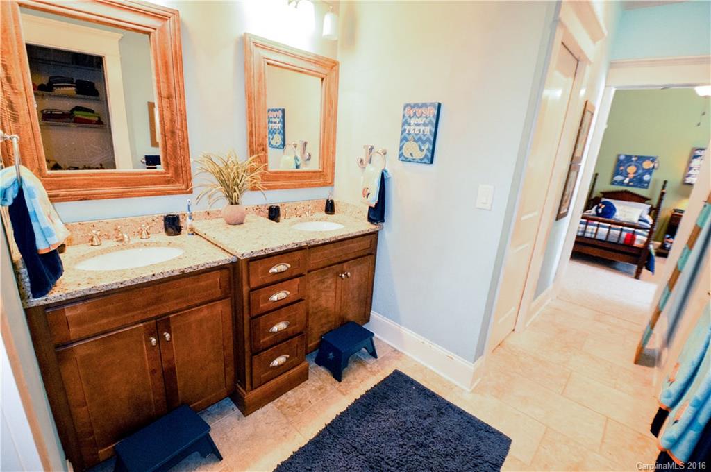 1024 Perriwinkle Lane Fort Mill, SC 29708 - Photo 19 of 24 a bathroom with a sink a vanity and a mirror