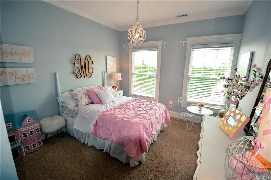 1024 Perriwinkle Lane Fort Mill, SC 29708 - Photo 21 of 24 a bed room with a bed and a chandelier