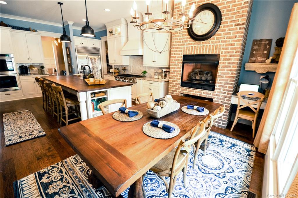 1024 Perriwinkle Lane Fort Mill, SC 29708 - Photo 7 of 24 a dining room with furniture a fireplace and wooden floor