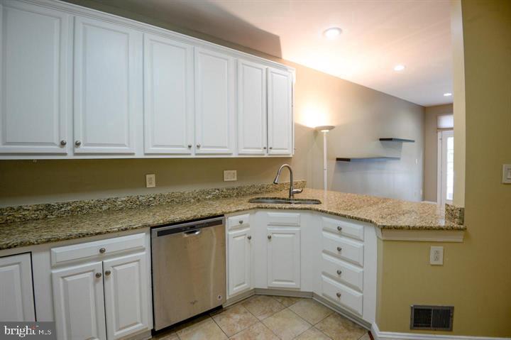 9404 Regency Crest Drive Vienna, VA 22181 - Photo 12 of 25 a kitchen with granite countertop stainless steel appliances white cabinets granite counter tops and a sink