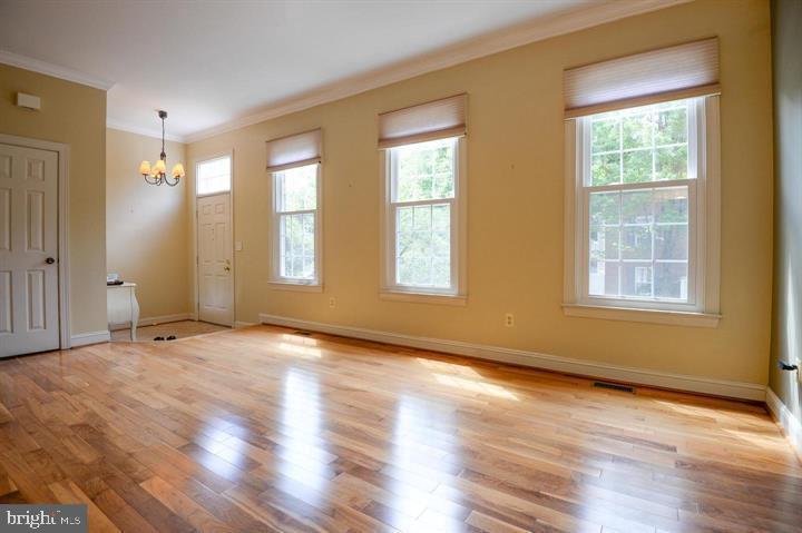 9404 Regency Crest Drive Vienna, VA 22181 - Photo 3 of 25 a view of an empty room with wooden floor and a window