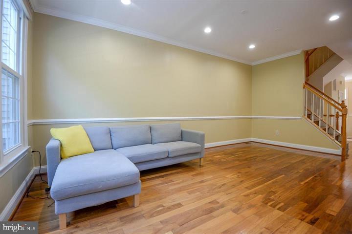 9404 Regency Crest Drive Vienna, VA 22181 - Photo 6 of 25 a living room with couches and a coffee table with wooden floor