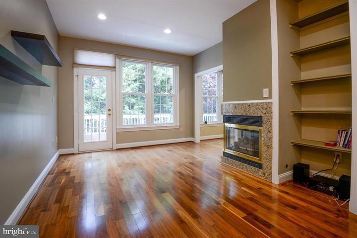 9404 Regency Crest Drive Vienna, VA 22181 - Photo 9 of 25 a view of empty room with wooden floor and fireplace