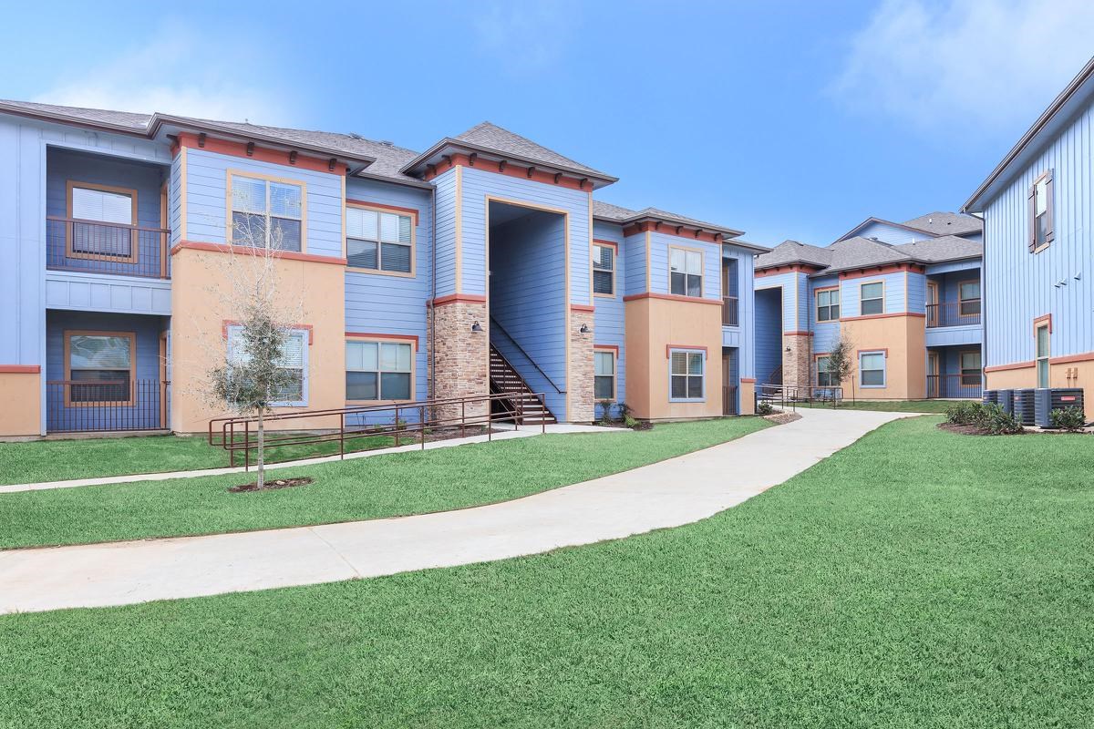 8501 Casa Verde Road, Unit 20 Laredo, TX 78041 - Photo 3 of 6 a front view of a house with a yard