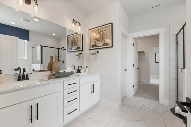 a bathroom with a granite countertop sink mirror and double