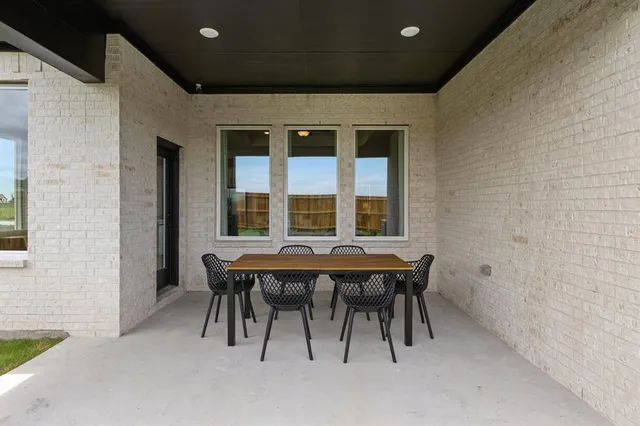 a balcony with table and chairs