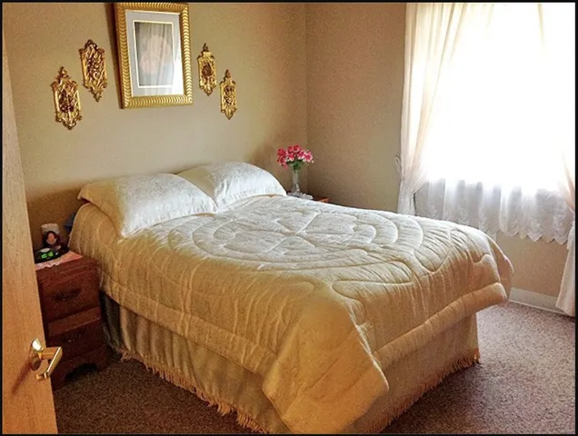 a bedroom with a bed and window