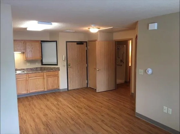 a view of a kitchen with a sink and a refrigerator