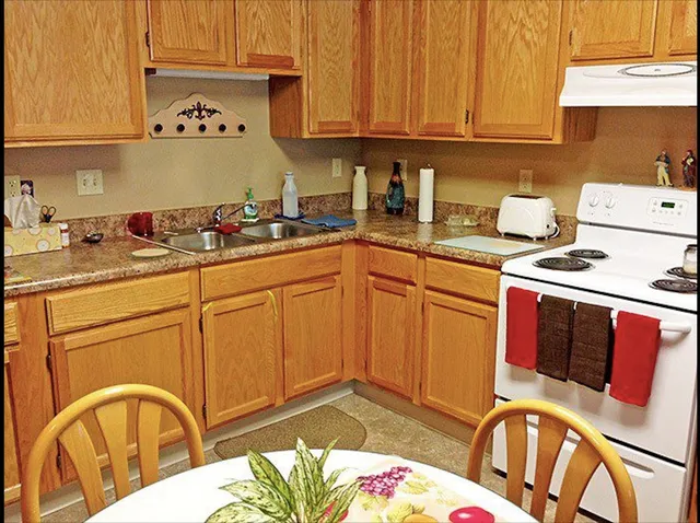 a kitchen with stainless steel appliances granite countertop a sink a stove and cabinets
