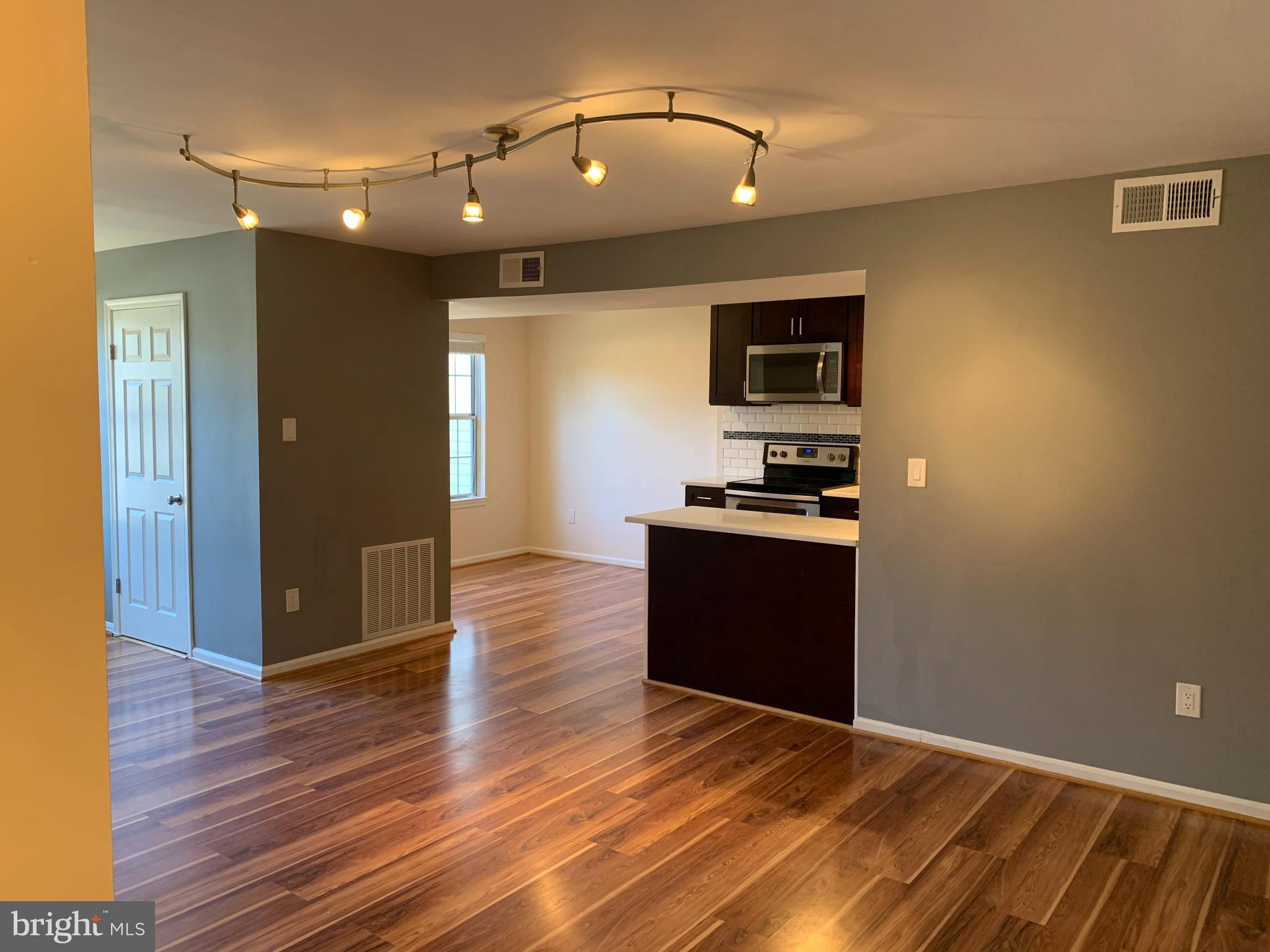 2 Normandy Square Court, Unit D Silver Spring, MD 20906 - Photo 1 of 23 a view of a room with wooden floor and kitchen