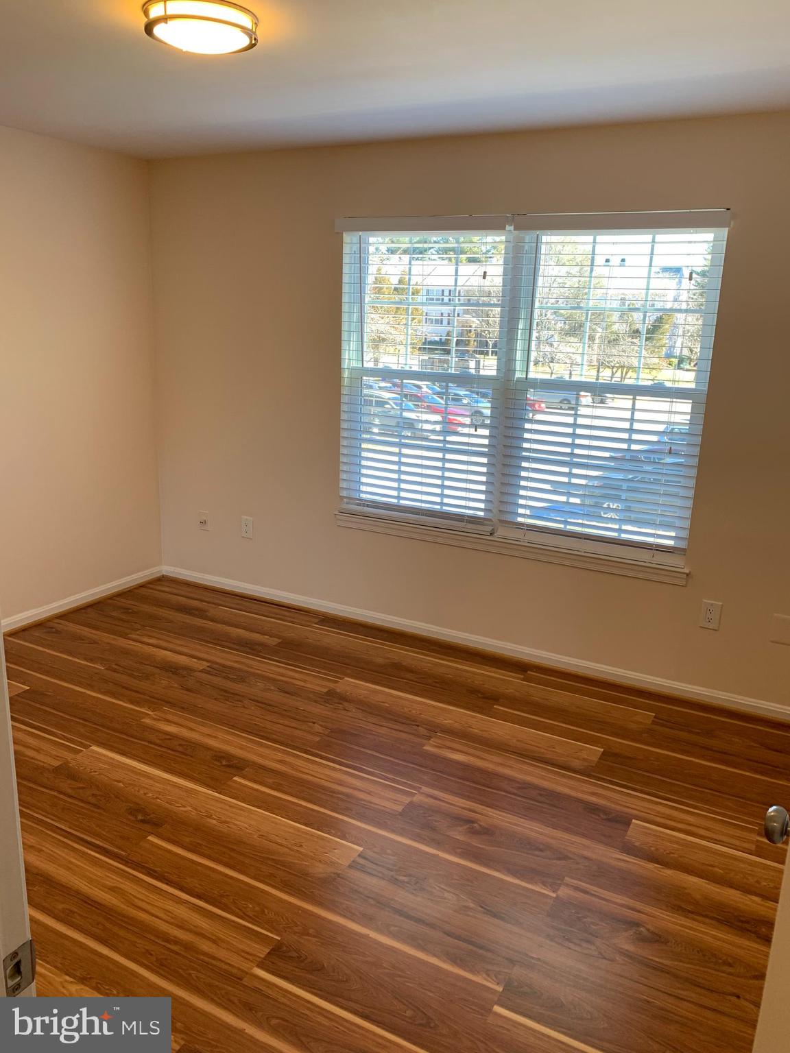 2 Normandy Square Court, Unit D Silver Spring, MD 20906 - Photo 13 of 23 a view of a room with wooden floor and windows