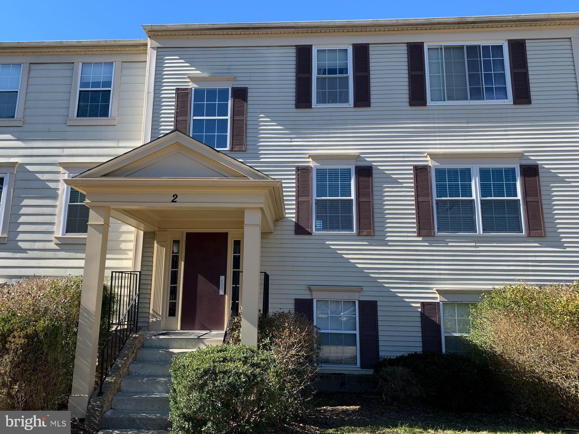 2 Normandy Square Court, Unit D Silver Spring, MD 20906 - Photo 2 of 23 a front view of a house with garden