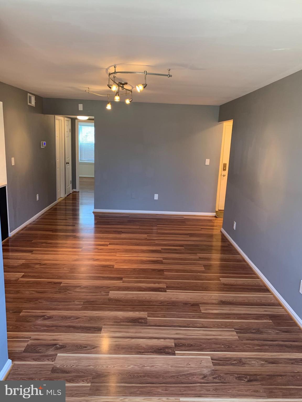 2 Normandy Square Court, Unit D Silver Spring, MD 20906 - Photo 4 of 23 a view of a livingroom with a ceiling fan and wooden floor