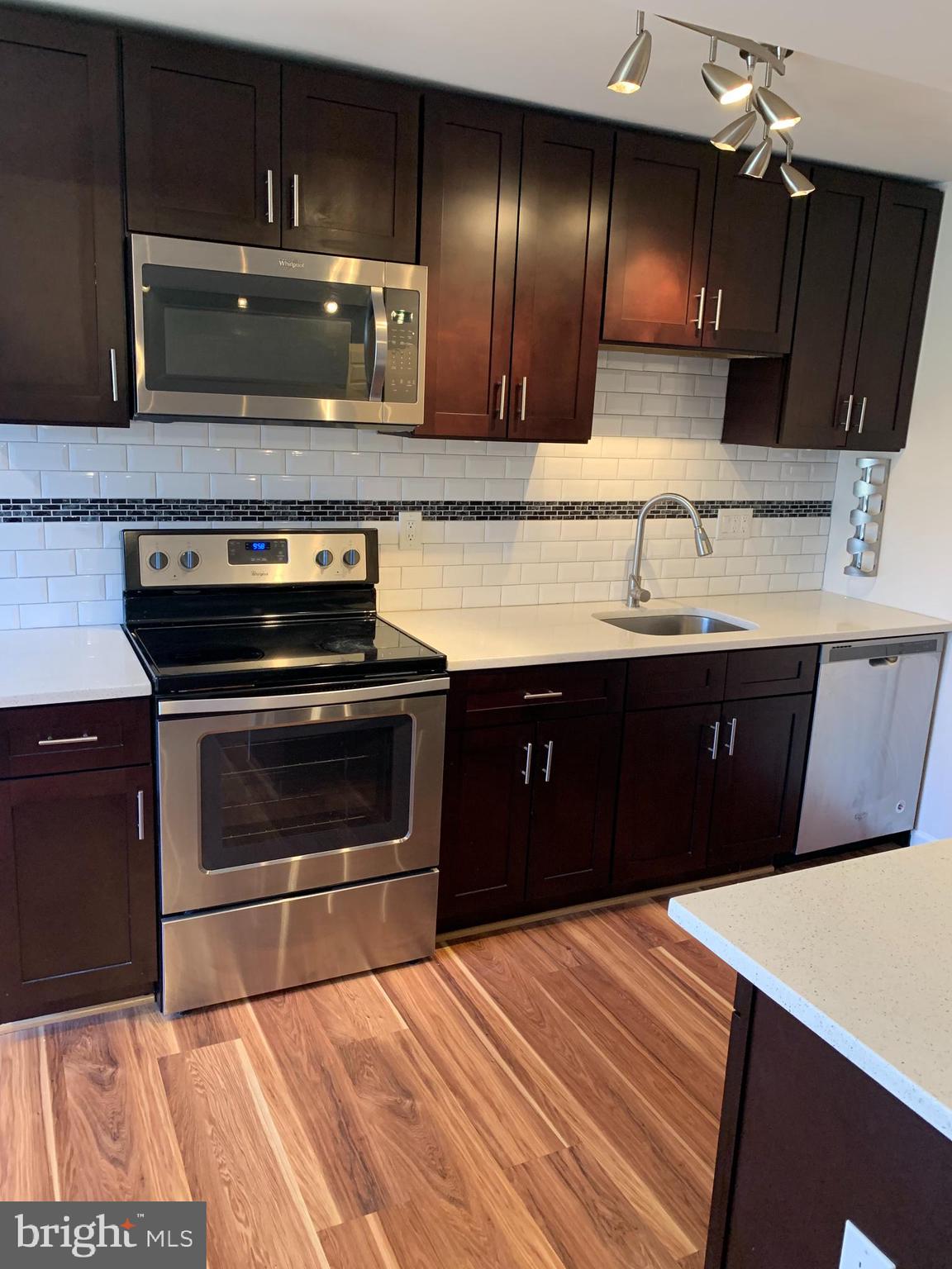 2 Normandy Square Court, Unit D Silver Spring, MD 20906 - Photo 7 of 23 a kitchen with a sink and a stove
