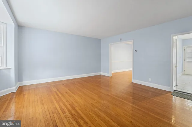a view of an empty room with wooden floor