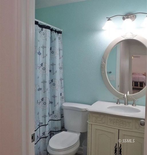 959 Jefferson Street Ridgecrest, CA 93555 - Photo 14 of 24 a bathroom with a sink a toilet and shower