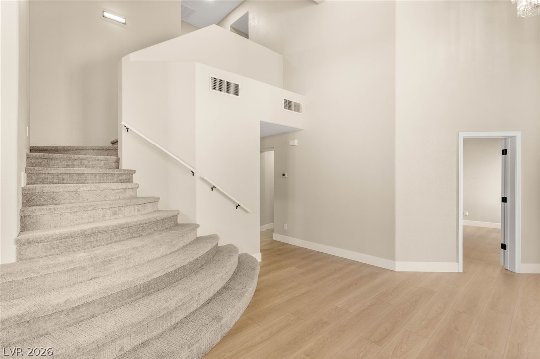 2104 Inverness Drive Henderson, NV 89074 - Photo 22 of 51 Stairway with a high ceiling and wood finished floors