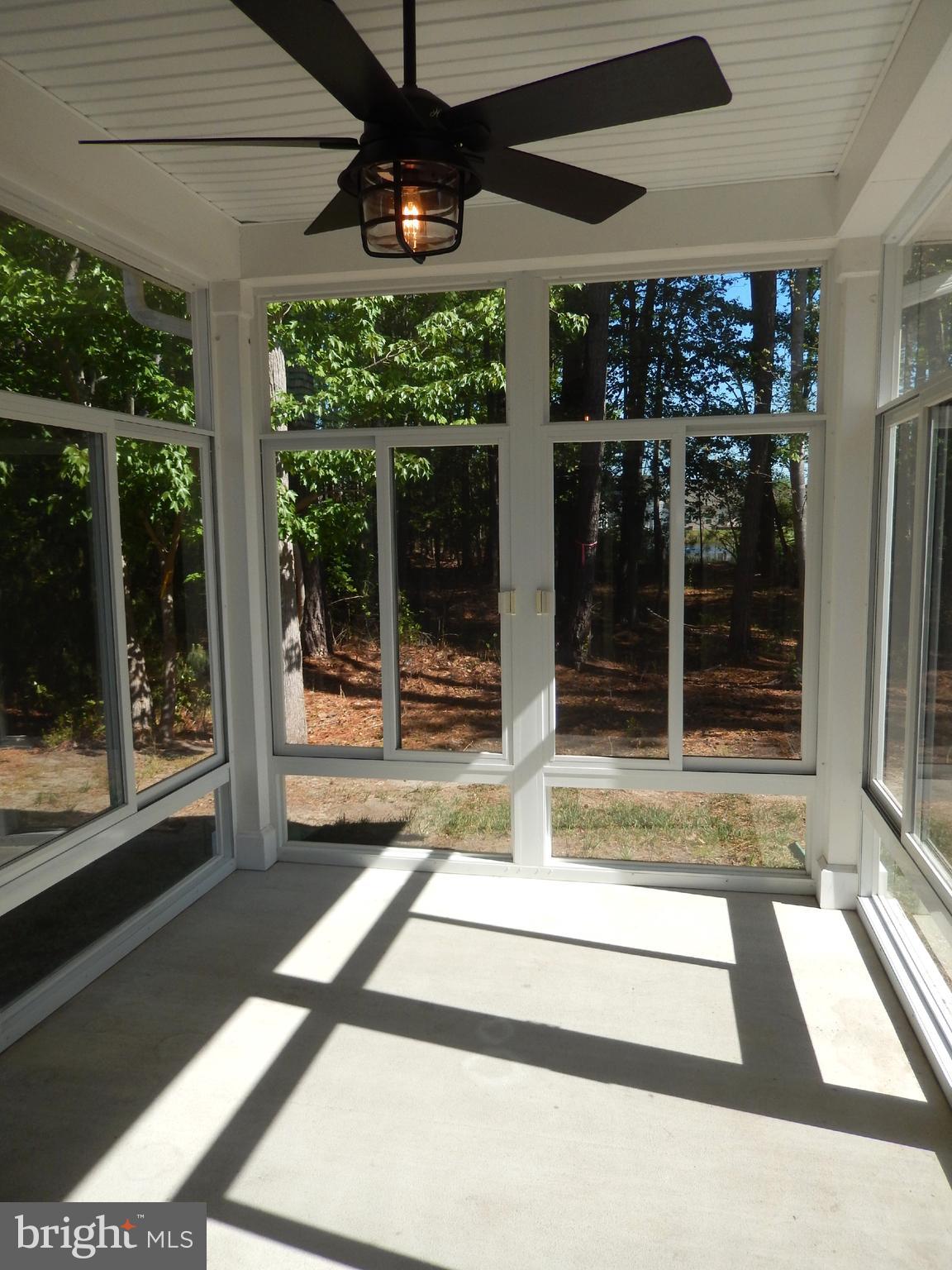 36884 Red Cedar Loop Ocean View, DE 19970 - Photo 20 of 50 a view of a porch with a floor to ceiling window and front door