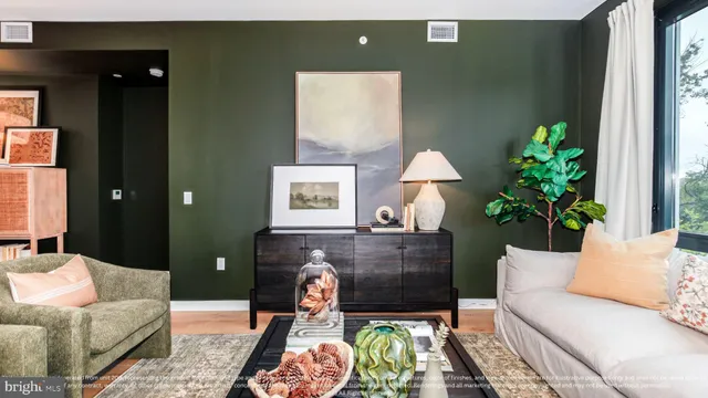 a living room with furniture and a potted plant