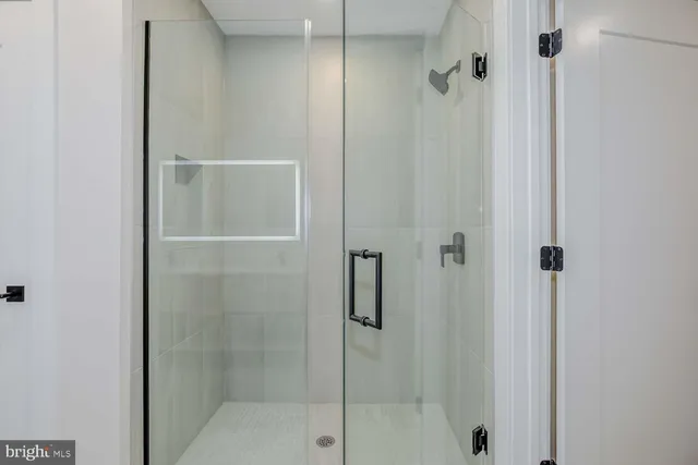 a bathroom with a glass shower door