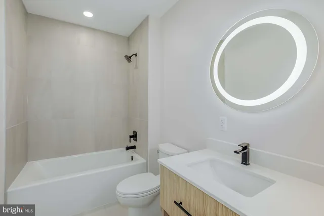 a bathroom with a sink a toilet and bathtub