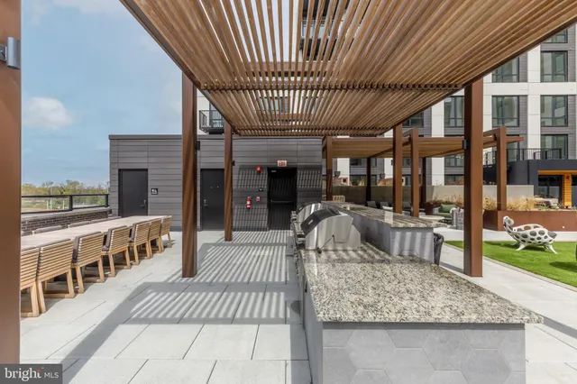 a view of a patio with couches potted plants and a big yard