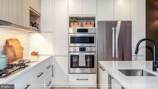 a kitchen with a sink and stainless steel appliances