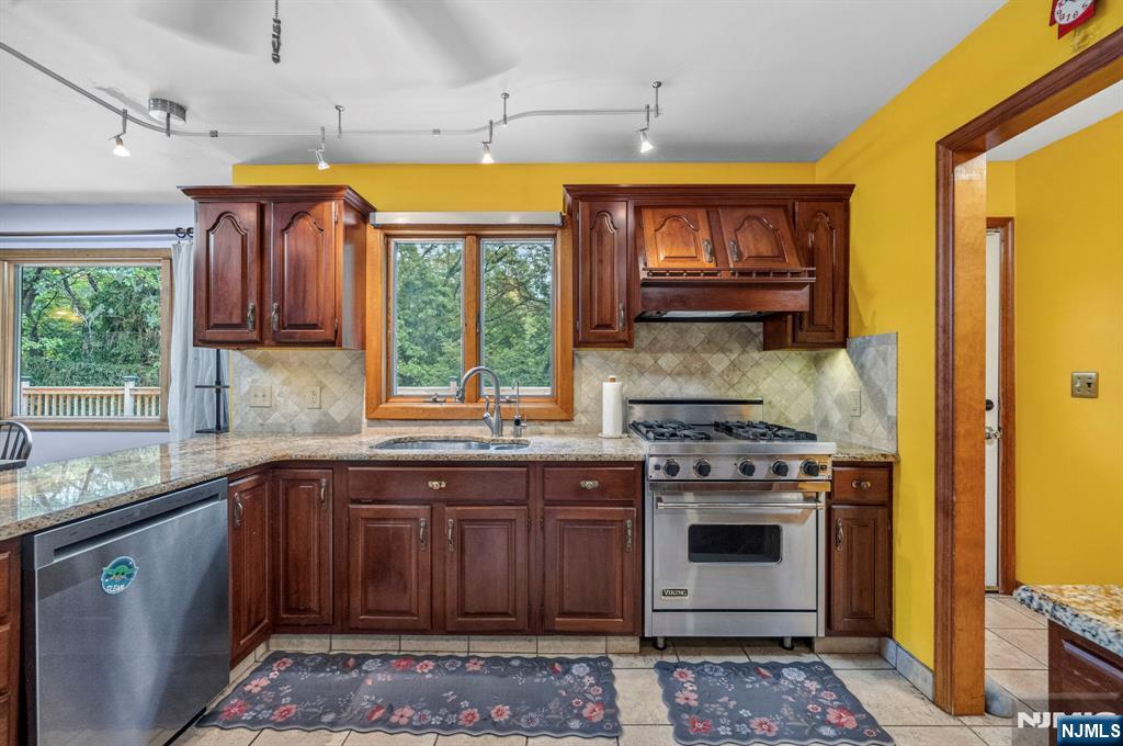 5110 Berkshire Valley Road Oak Ridge, NJ 07438 - Photo 18 of 49 a kitchen with stainless steel appliances granite countertop a stove a sink and a microwave